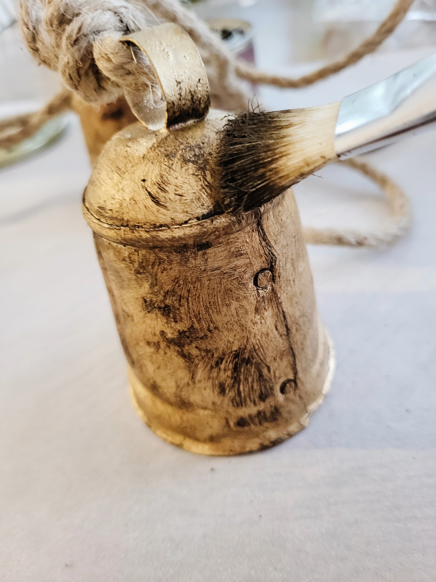 brushing decorative antique wax on brass bells